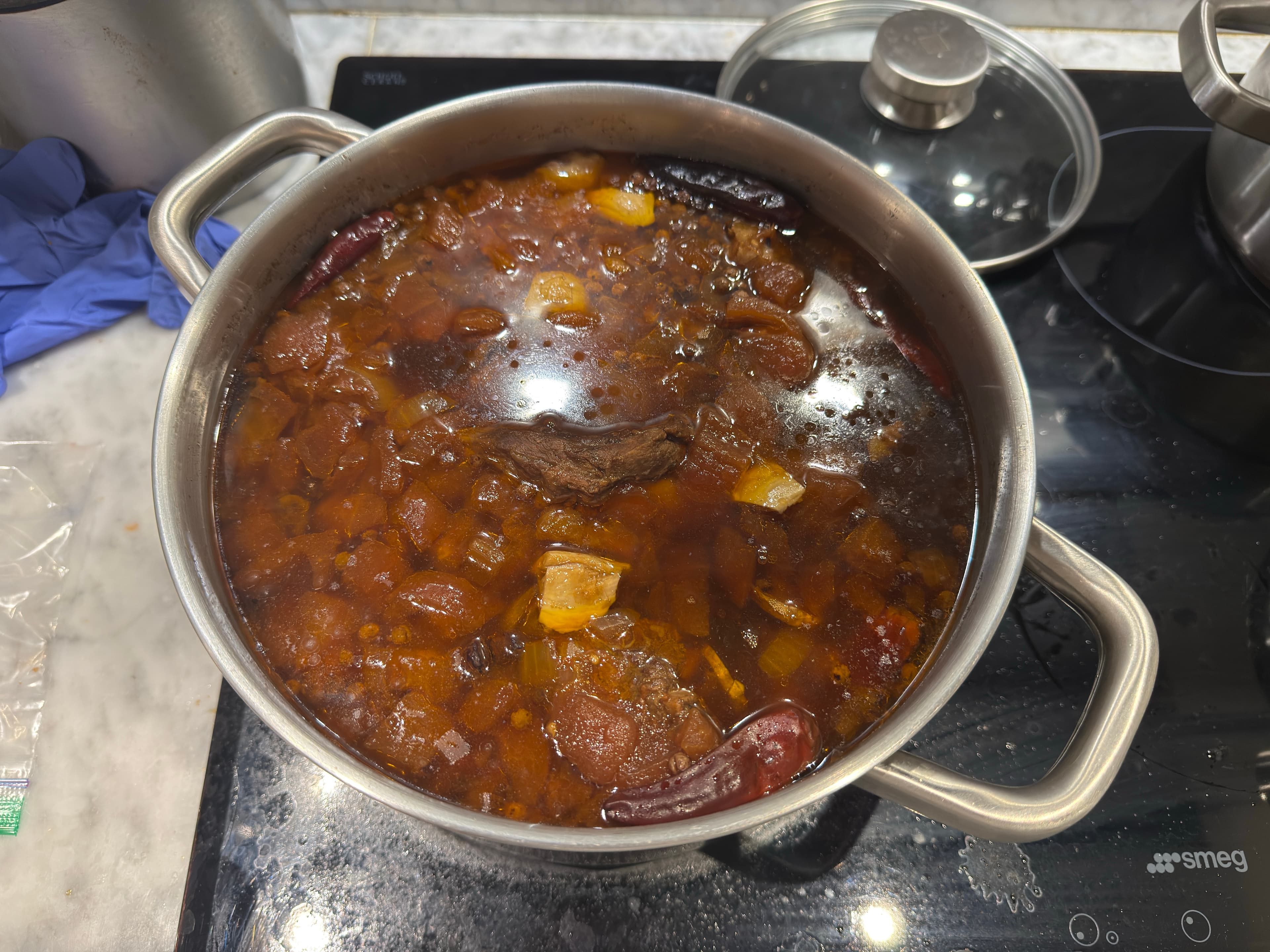 A bowl of beef back ribs tomato soup with tender ribs, tomato-rich broth, and soft vegetables.